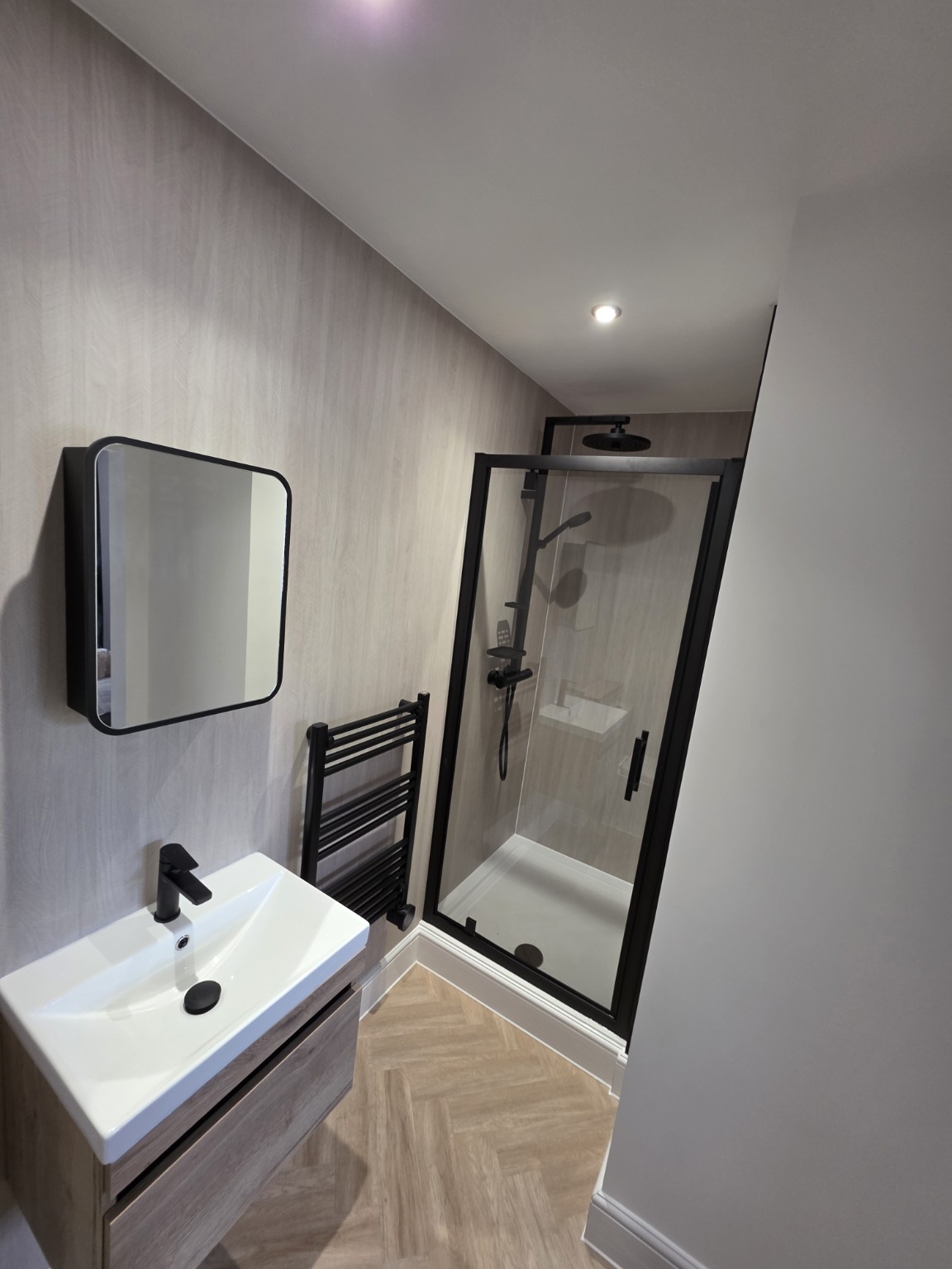 Renovated bathroom with shower and basin