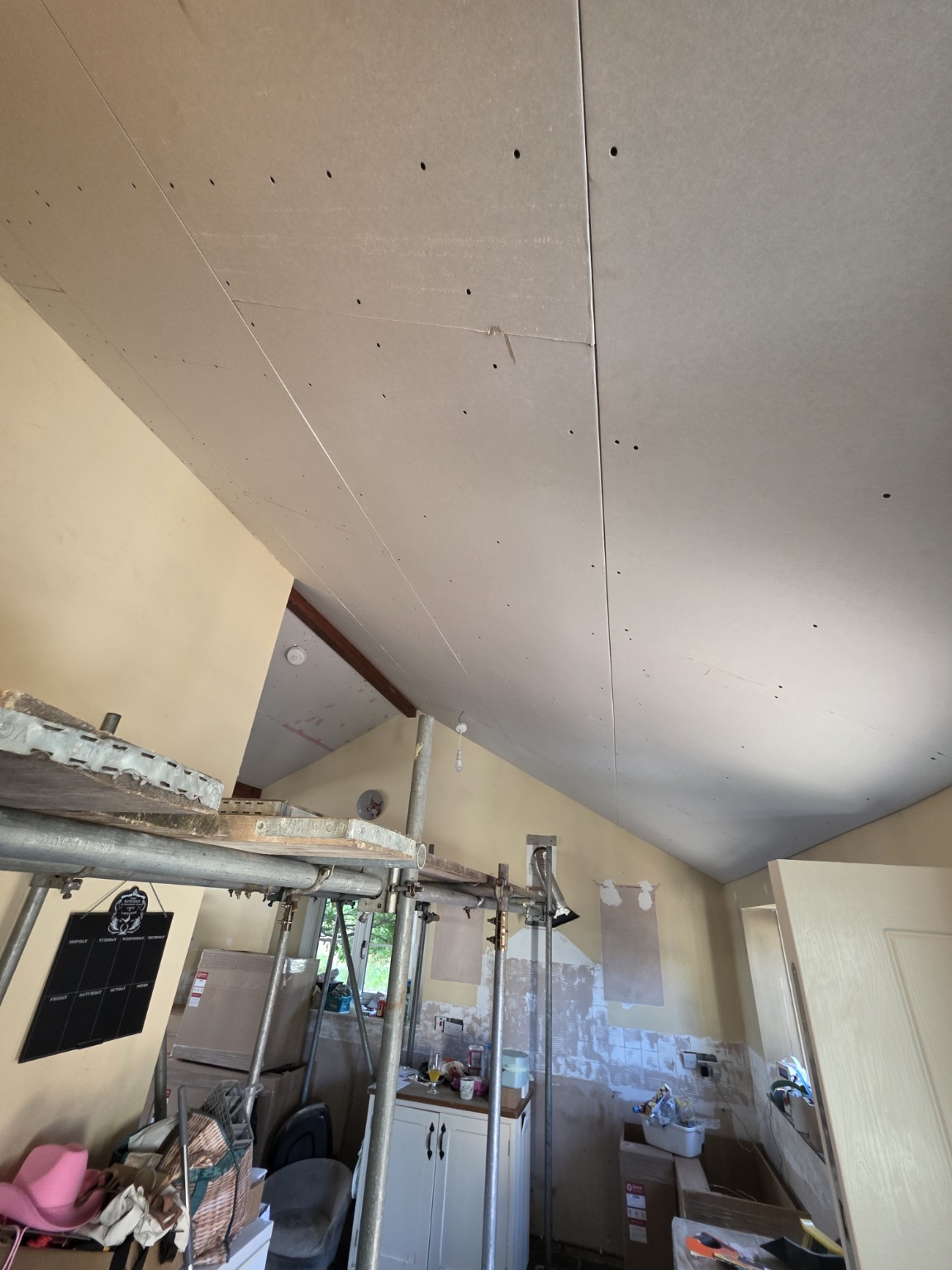 Plasterboard ceiling and exposed beams during preparation