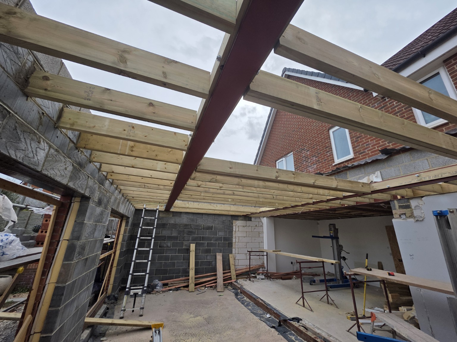 Interior of an extension showing steel beams and timber roof structure